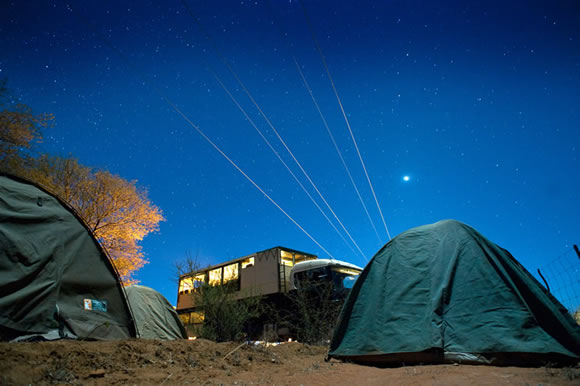 Evening campsite with safari truck and tents